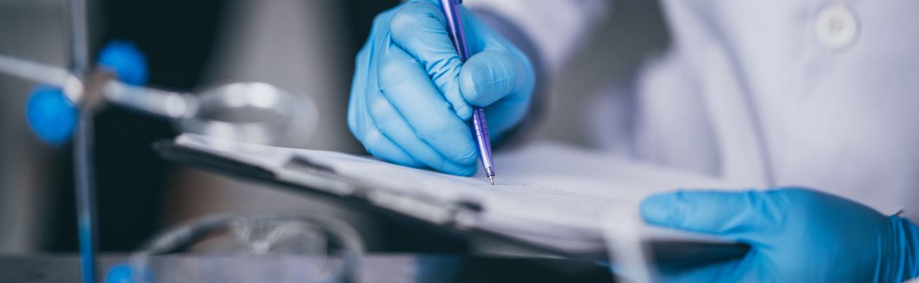 researchers wearing blue gloves writing in a notepad